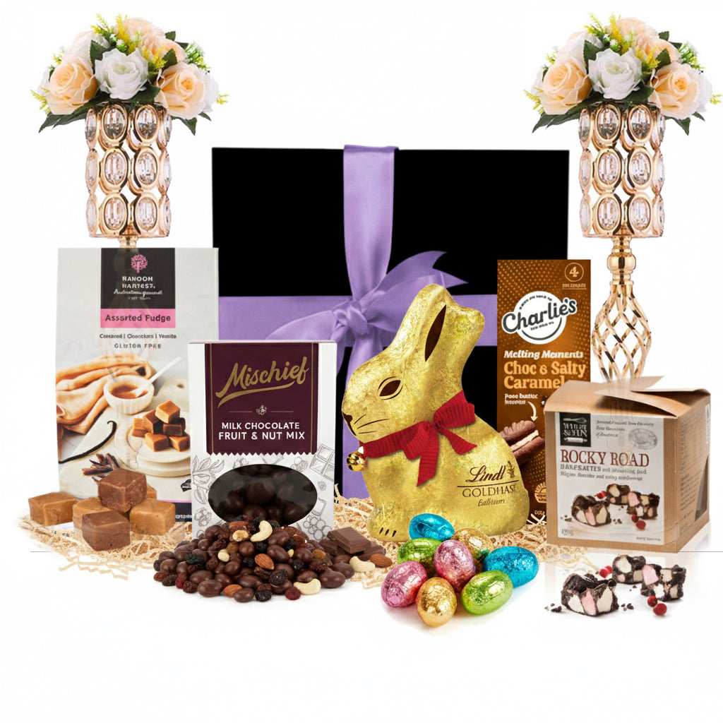 Golden chocolate gift hamper with Gold Bunny, fudge and rocky road beside a black gift box