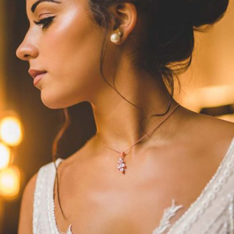 Close-up of a woman wearing a delicate necklace with a blurred background