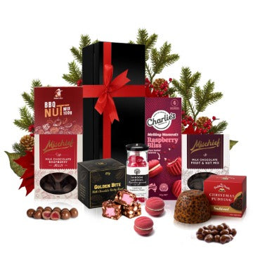 Christmas chocolate and snacks gift hamper in a black gift box with red ribbon